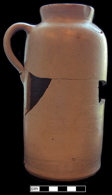 North American pale grey-bodied salt glazed handled jug.  The straight sides and definite shoulder on this vessel suggest that it was made after circa 1850. Rim diameter: 2.75”, base diameter: 4.00”, vessel height:  8.00”, from 18QU124.